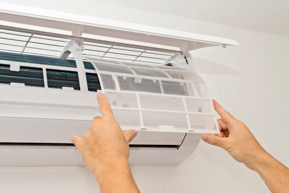 Unlocking the Mystery of AC Air Filters: Your Ultimate Guide to Enhanced Home Comfort - Person changing filter on a ductless ac unit.