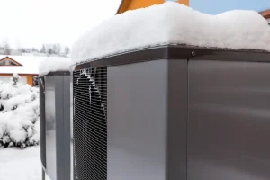 Modern Heat Pump With Snow on Top, how does a heat pump work in winter? Perfect Temp