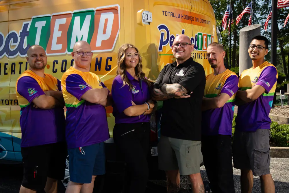 Unmatched HVAC services in Huntley, IL - Group photo of Perfect Temp team in front of a company branded van.