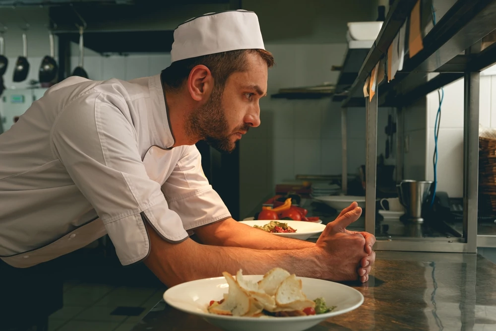 stressed chef leaning on counter
